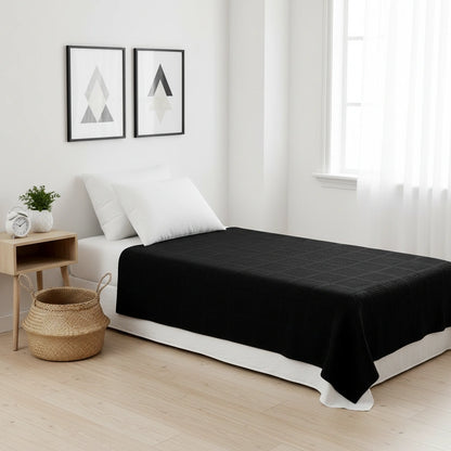 zwarte plaid van 100% katoen op een luxe eenpersoons bed